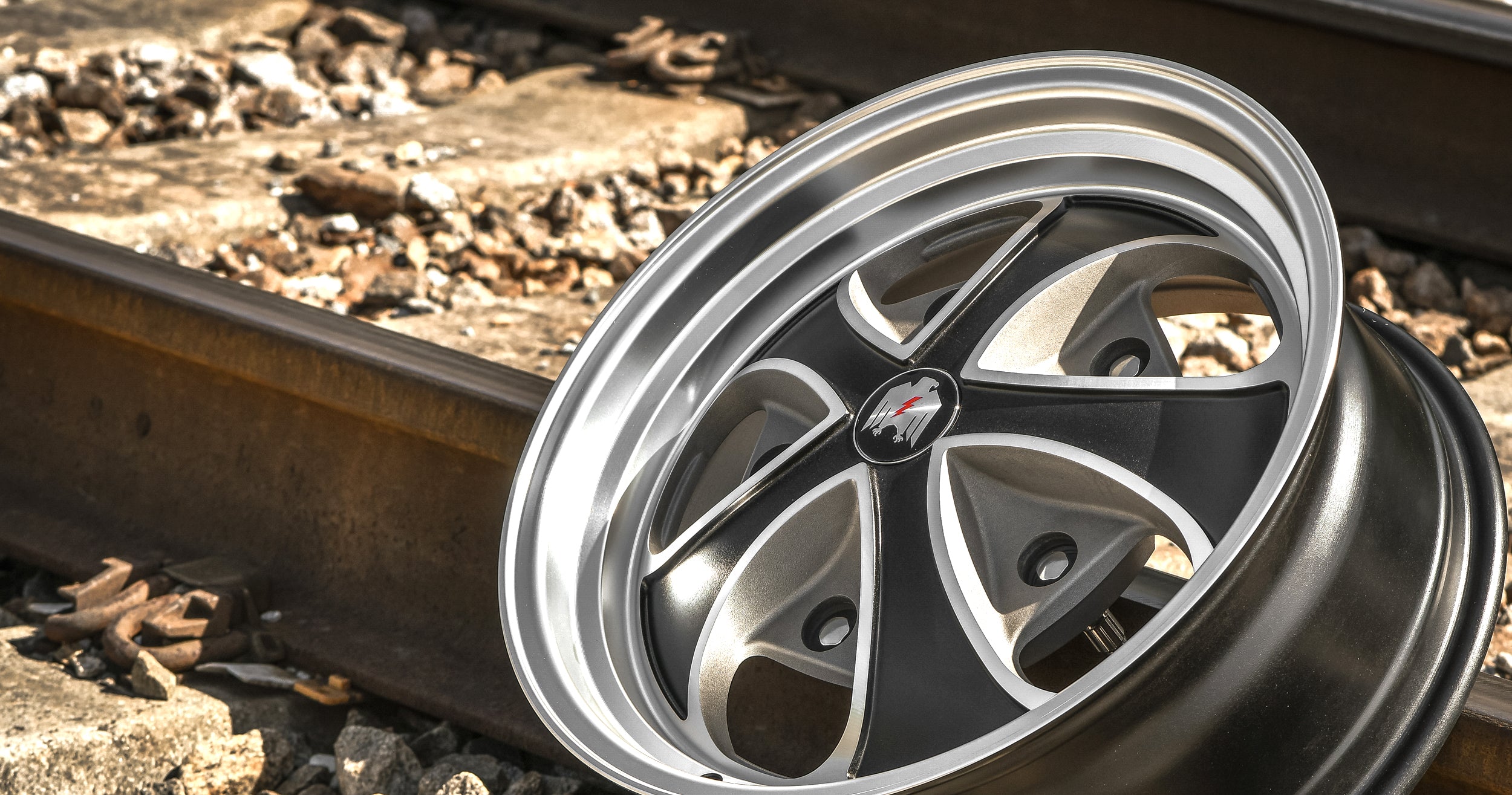 Klassik Rader Wheels Falcon Satin Black with vintage Gray Machined Face & Lip on railroad tracks